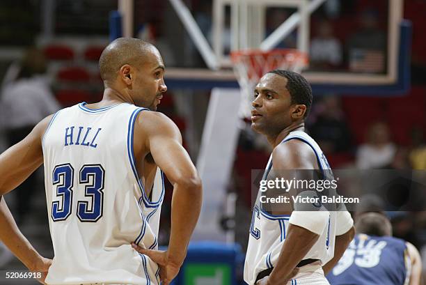 Grant Hill talks with Cuttino Mobley of the Orlando Magic during the game with the Memphis Grizzlies at TD Waterhouse Centre on March 31, 2004 in...