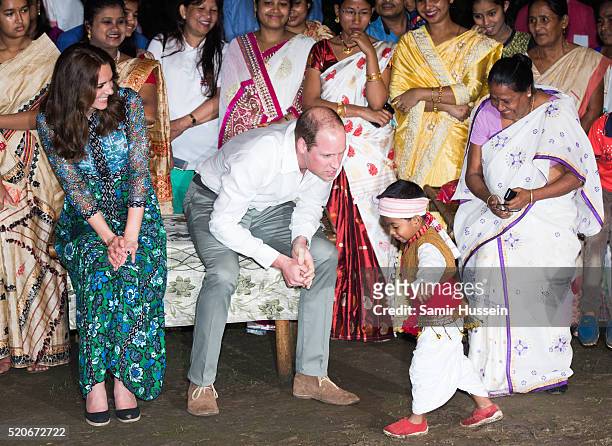 Prince William, Duke of Cambridge and Catherine, Duchess of Cambridge watch a boy dance during a Bihu Festival Celebration at Diphlu River Lodge...