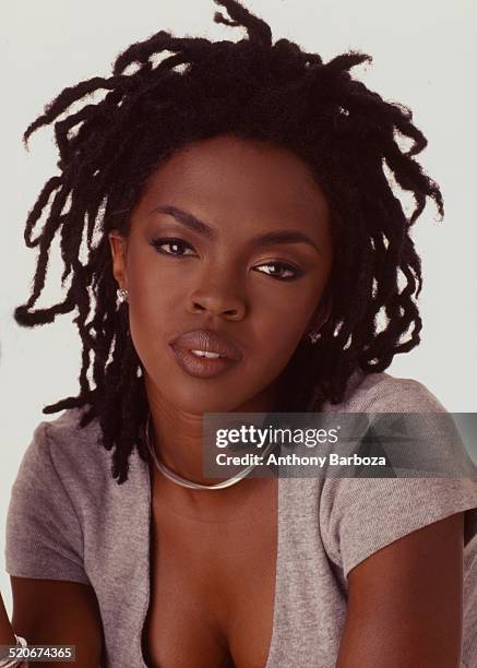 Portrait of American pop and rhythm & blues musician Lauryn Hill as she poses against a white background, 1998.