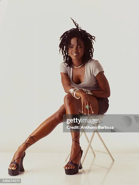 Portrait of American pop and rhythm & blues musician Lauryn Hill as she poses against a white background, 1998.