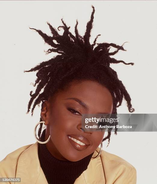 Portrait of American pop and rhythm & blues musician Lauryn Hill as she poses against a white background, 1998.