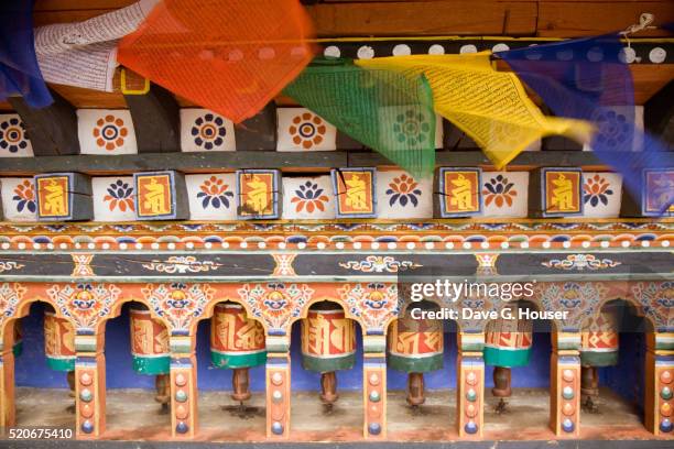 prayer wheels and flags of a buddhist chorten - prayer wheel stock pictures, royalty-free photos & images