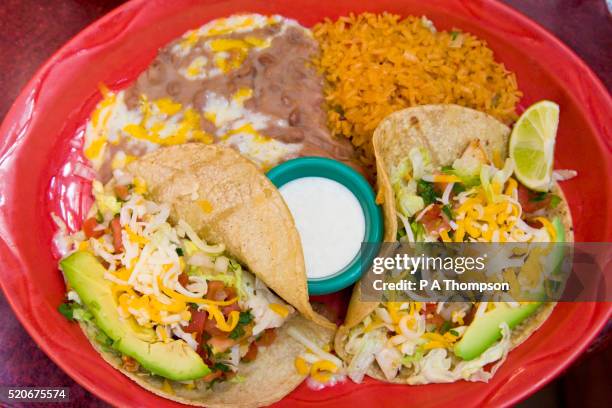 tacos dinner with rice and re fried beans - mexican food stock pictures, royalty-free photos & images