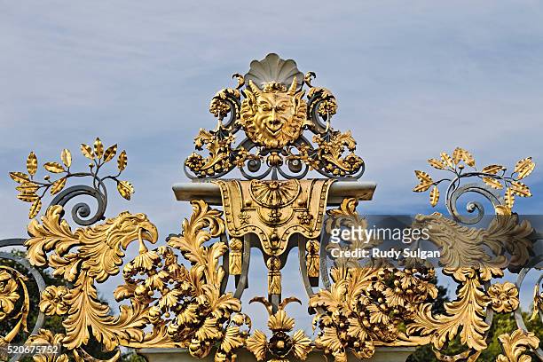 detail of ornamental wrought iron gate at hampton court palace - hampton court stock pictures, royalty-free photos & images
