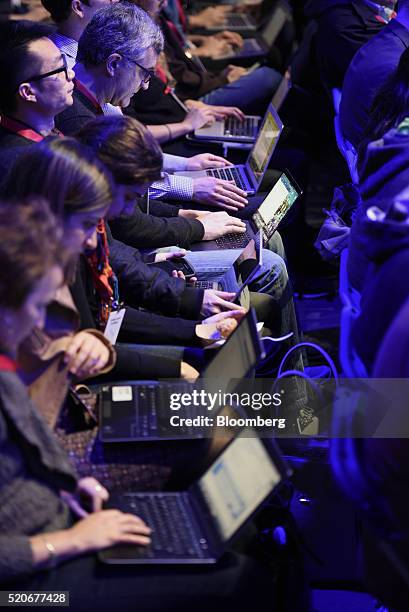 Attendees work on laptops as Mark Zuckerberg, founder and chief executive officer of Facebook Inc., not pictured, speaks during the Facebook F8...