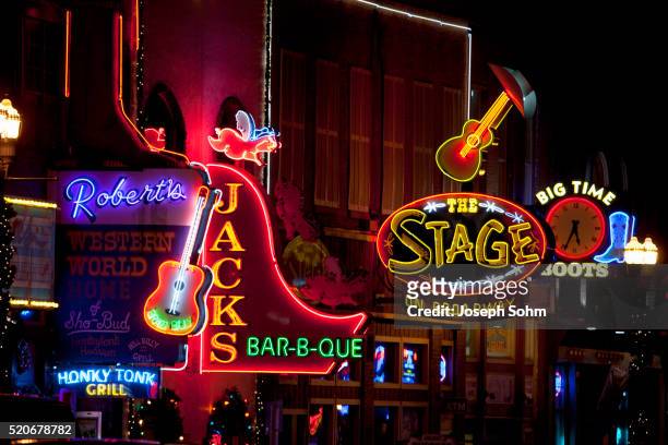 neon lights of lower broadway, nashville, tn - nashville stock pictures, royalty-free photos & images