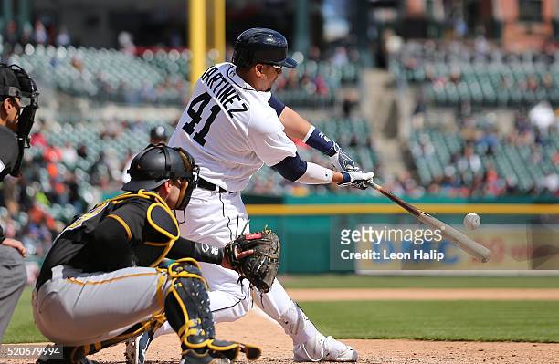 Victor Martinez of the Detroit Tigers doubles to deep center field scoring Ian Kinsler and Justin Upton during the sixth inning of the inter-league...