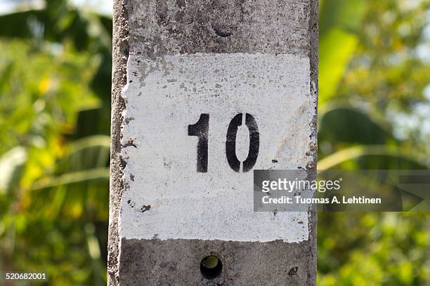 painted number ten on a concrete column outdoors - roman numeral ten stock pictures, royalty-free photos & images
