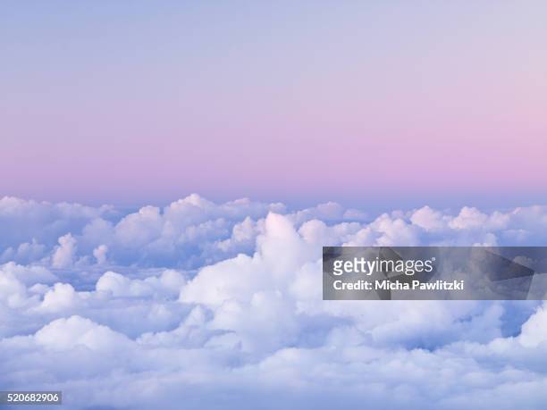 first light on clouds over haleakala national park - nuvens fofas imagens e fotografias de stock