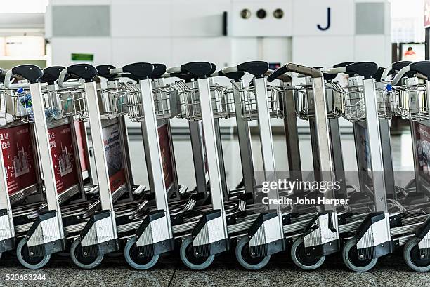baggage trolleys, hong kong international airport, hong kong - hong kong international airport stock pictures, royalty-free photos & images