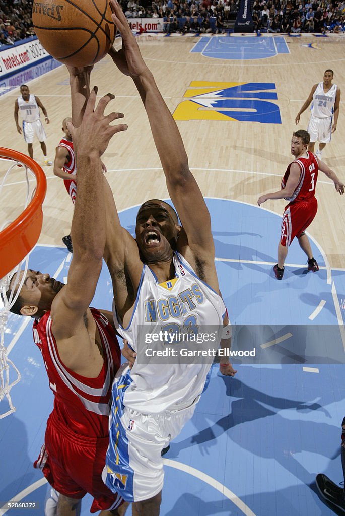Houston Rockets Marcus Marcus Camby of the Denver Nuggets shoots against Juwan Howard of the ...