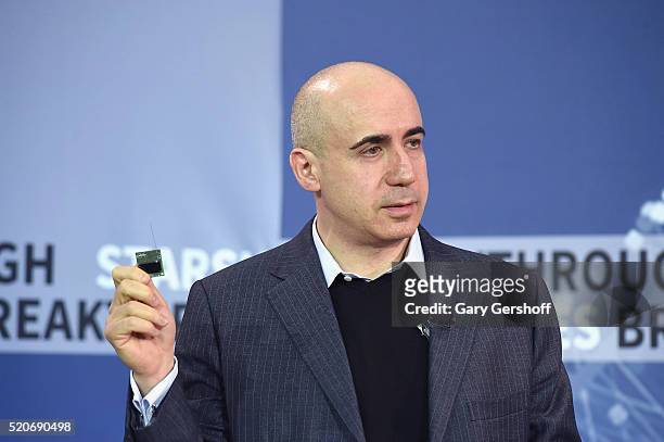 Internet investor and science philanthropist Yuri Milner demonstrates the StarChip during the New Space Exploration Initiative "Breakthrough...