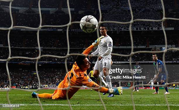 Cristiano Ronaldo of Real Madrid beats goalkeeper Diego Benaglio of VfL Wolfsburg to score their first goal during the UEFA Champions League quarter...