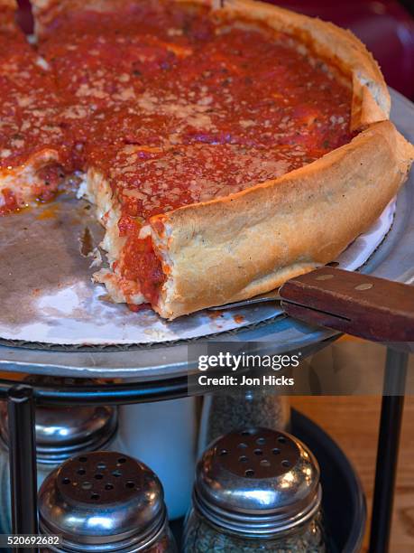 a chicago-style deep-dish pizza. - deep dish pizza stock pictures, royalty-free photos & images