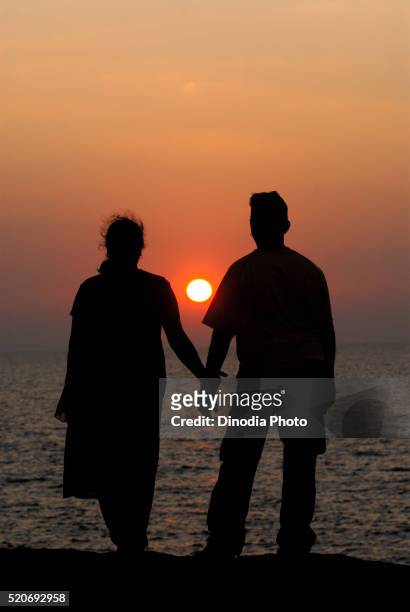 couple watching sunset at harihareshwar raigad maharashtra india asia - married silhouette stock pictures, royalty-free photos & images