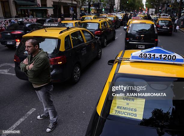 Cabs block Mayo avenue as taxi drivers protest against Uber in Buenos Aires on April 12, 2016. Uber started operating in Buenos Aires Tuesday without...