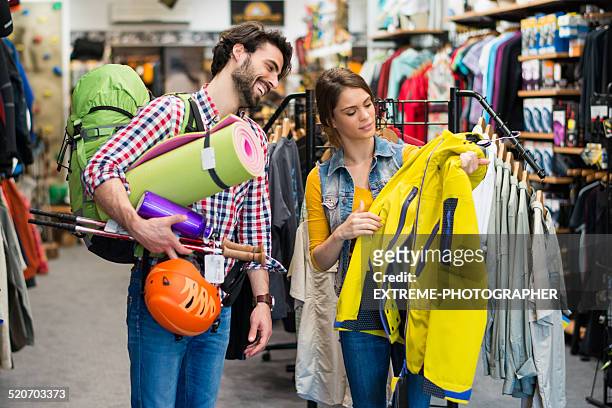 man looking to buy jacket and outdoor equipment - sports equipment stock pictures, royalty-free photos & images