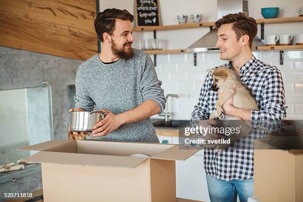 the beginning of a new chapter in life - gay couple new house stock pictures, royalty-free photos & images