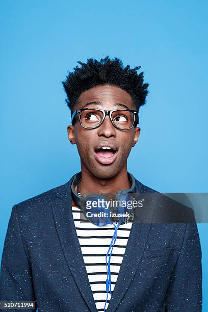 fashionable afro american young man against blue background - man expressive background glasses stock pictures, royalty-free photos & images