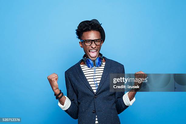 fashionable afro american guy expressing happiness - champions portrait stock pictures, royalty-free photos & images