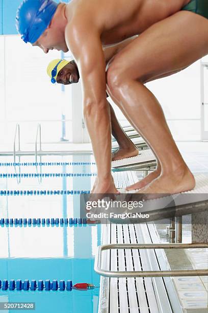 swimmers on starting blocks - starter pistol stock pictures, royalty-free photos & images