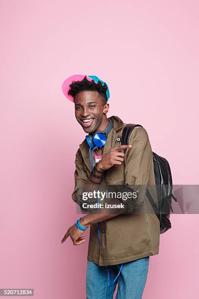 studio portrait of funky, excited afro american student - portrait young colour background cool stockfoto's en -beelden