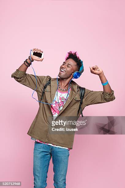 excited afro american guy wearing headphone, dancing - young men dance stock pictures, royalty-free photos & images