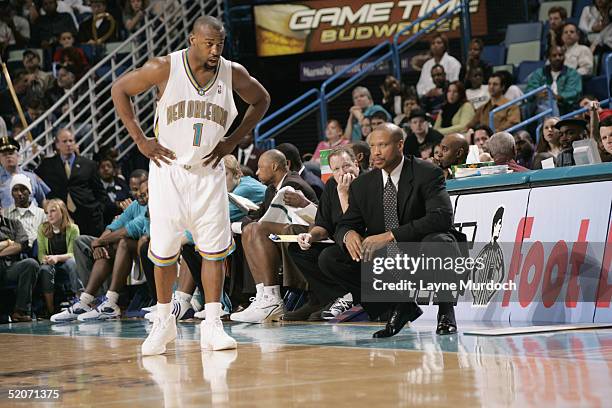 Baron Davis of the New Orleans Hornets stands next to his head coach Byron Scott during the game against the Sacramento Kings on January 8, 2005 at...