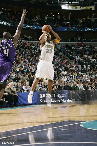 Smith of the New Orleans Hornets shoots over Chris Webber of the Sacramento Kings during the game on January 8, 2005 at the New Orleans Arena in New...