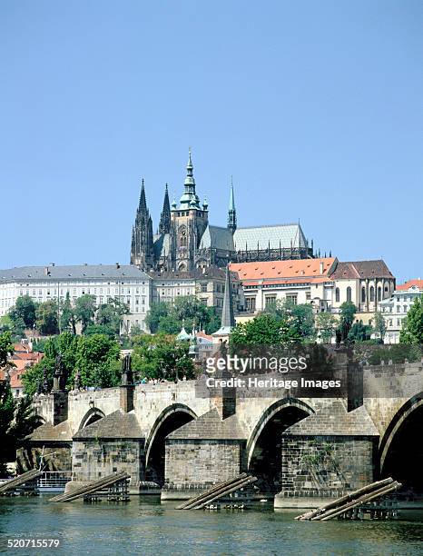 The Charles Bridge the castle and St Vitus Cathedral, Prague, Czech Republic. View across the waters of the Vltava towards the 14th century Charles...