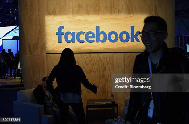 Attendees sit in front of signage displayed during the Facebook F8 Developers Conference in San Francisco, California, U.S., on Tuesday, April 12,...