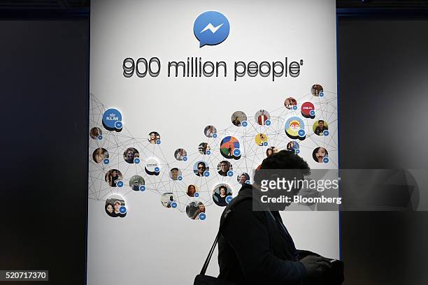 An attendee walks past messenger signage during the Facebook F8 Developers Conference in San Francisco, California, U.S., on Tuesday, April 12, 2016....