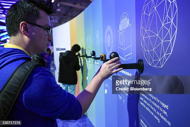 Attendees view a variety of 360 cameras at the Surround 360 camera booth during the Facebook F8 Developers Conference in San Francisco, California,...