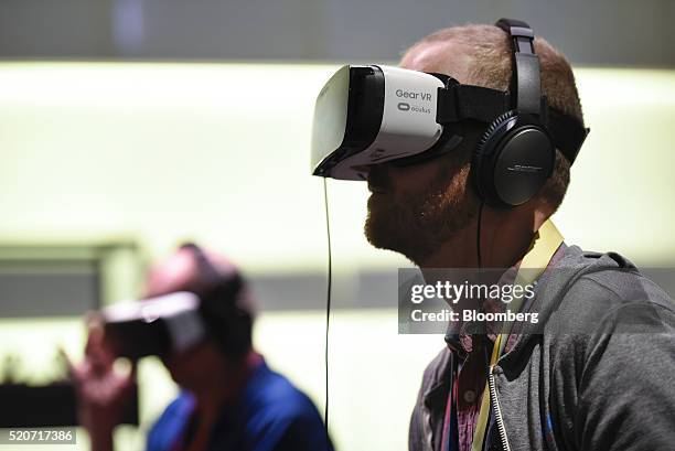 Attendees try out Gear VR glasses during the Facebook F8 Developers Conference in San Francisco, California, U.S., on Tuesday, April 12, 2016....