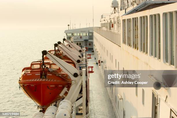 life boats on a north sea ferry from newcastle to amsterdam - barco salvavidas fotografías e imágenes de stock