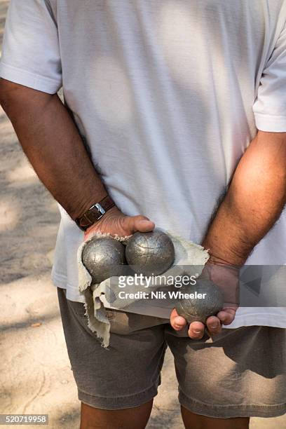 Petanque player awaits his turn to throw his boules during a tournament in Agde in Herault department in Languedoc Roussillon region of the South of...
