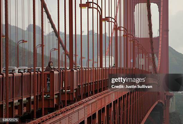 Man looks over the railing of the Golden Gate Bridge January 27, 2005 in San Francisco. A controversial film made by moviemaker Eric Steel...