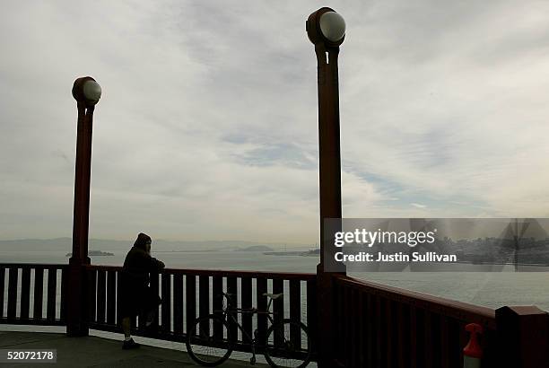 Man looks over the railing of the Golden Gate Bridge January 27, 2005 in San Francisco. A controversial film made by moviemaker Eric Steel...