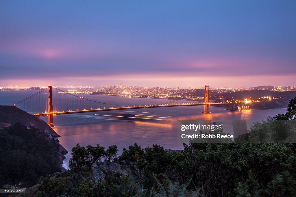 The Golden Gate Bridge, San Francisco skyline and San Francisco Bay in evening