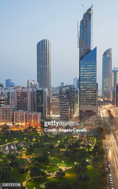 park and modern skyscrapers downtown abu dhabi - abu dhabi architecture stock pictures, royalty-free photos & images