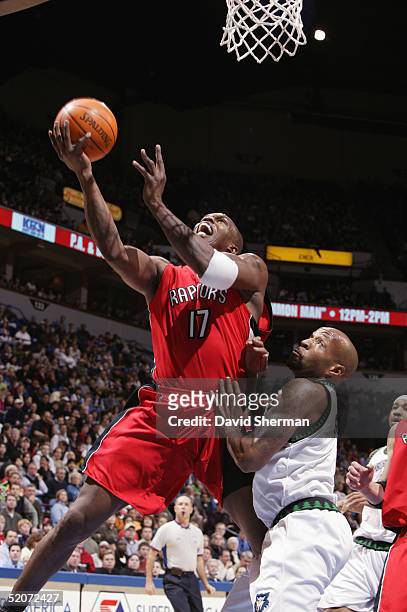 Eric Williams of the Toronto Raptors shoots a layup against Anthony Carter of the Minnesota Timberwolves during the game at Target Center on January...