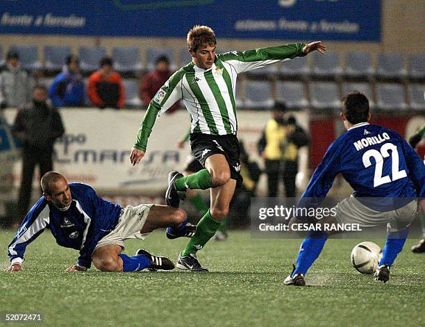 Betis' Joaquin Sanchez vies with Gramanet's Pages and Morillo during a King Cup soccer match in Barcelona 27 January 2005. AFP PHOTO/CESAR RANGEL