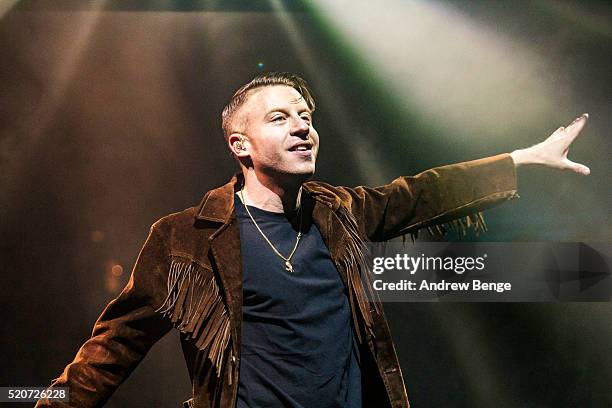 Macklemore of Macklemore & Ryan Lewis performs on stage at Manchester Arena on April 12, 2016 in Manchester, England.