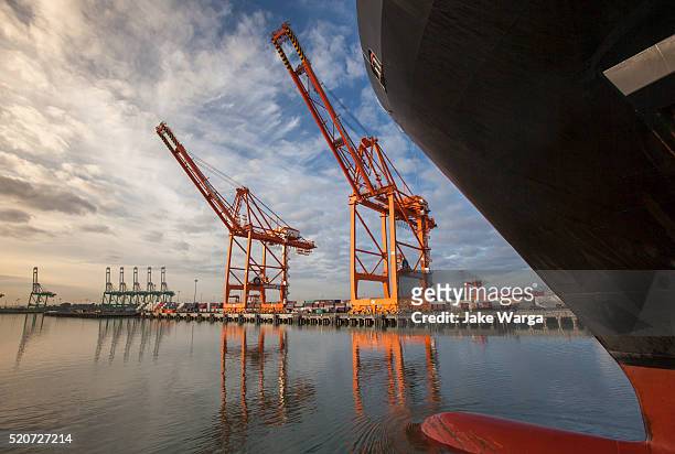 cargo ship loading cranes, harbor cranes - jake warga stock pictures, royalty-free photos & images