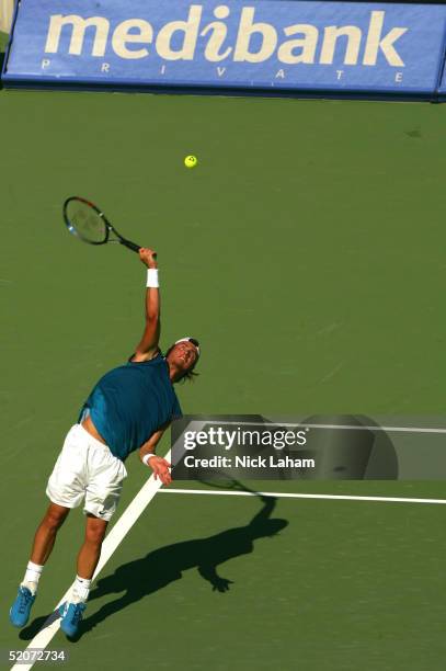 Lleyton Hewitt of Australia serves against Thomas Johansson of Sweden during day five of the Medibank Private International on January 13, 2005 at...