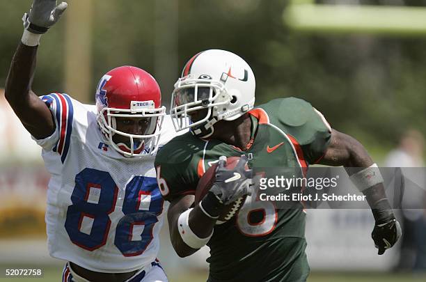 Defensive back Antrel Rolle of the University of Miami Hurricanes runs upfield from wide receiver Tramissian Davis of the Louisiana Tech Bulldogs...