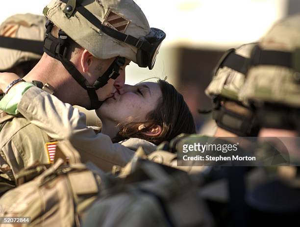 Army Spc. Bryan Pierce kisses his girlfriend Courtney Brown goodbye during the deployment of the 3/7th infantry brigade of the 3rd Infantry Division...