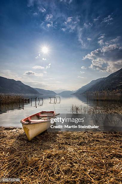 old red boat on waterside - carinthia stock pictures, royalty-free photos & images