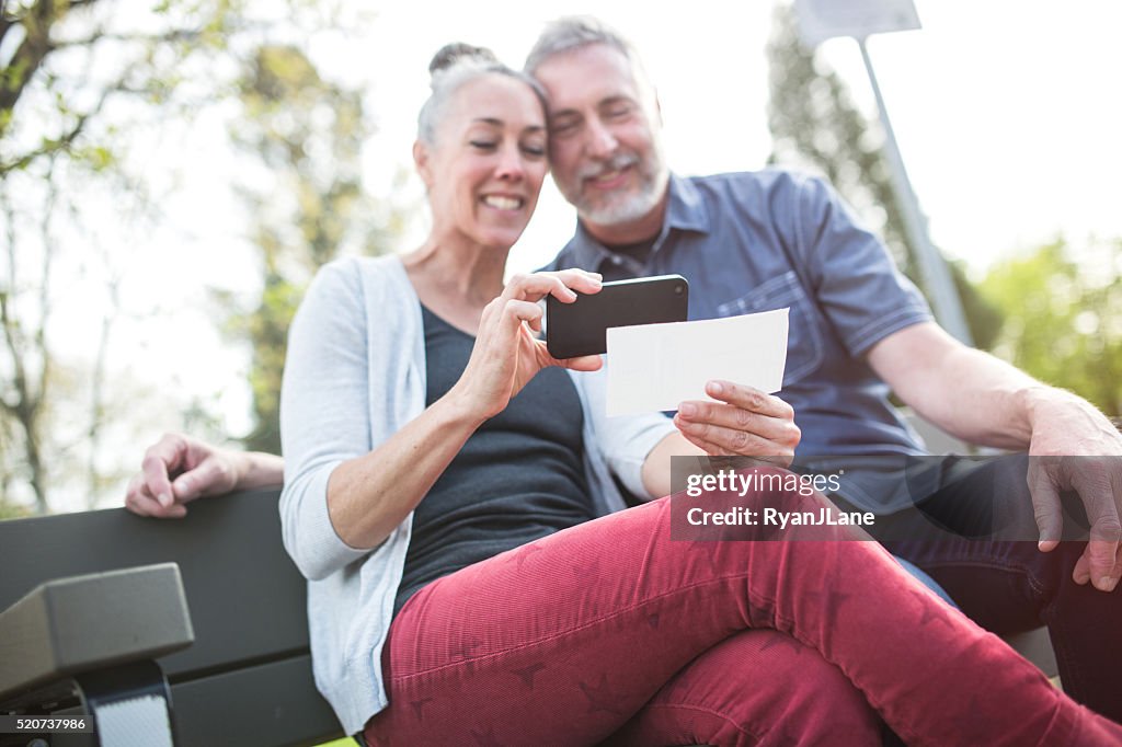 Mature Couple Remote Banking with Phone