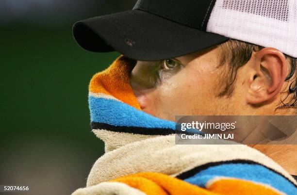 Second seed Andy Roddick of the US buries his face in a towell during a break against third seed Lleyton Hewitt of Australia in their men's singles...